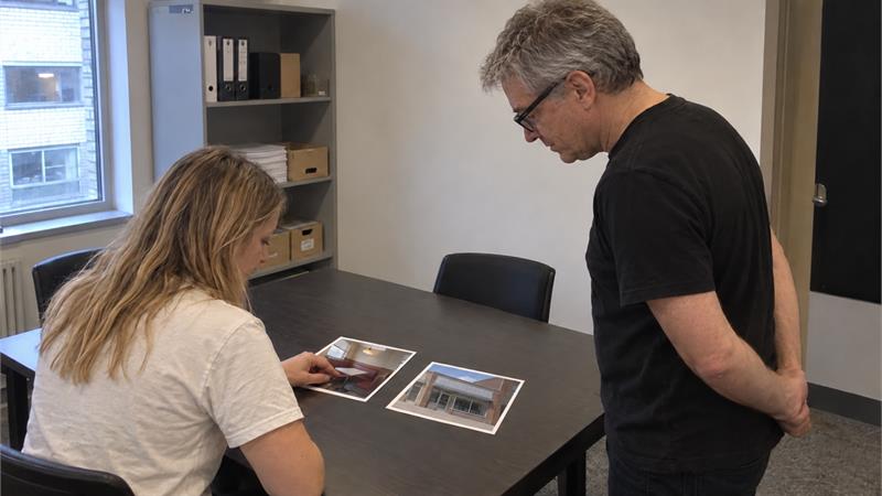 The Adfyo crew reviewing photographic prints at a work table